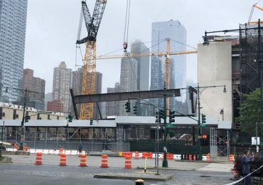 Crane drops steel beams at NYC construction site